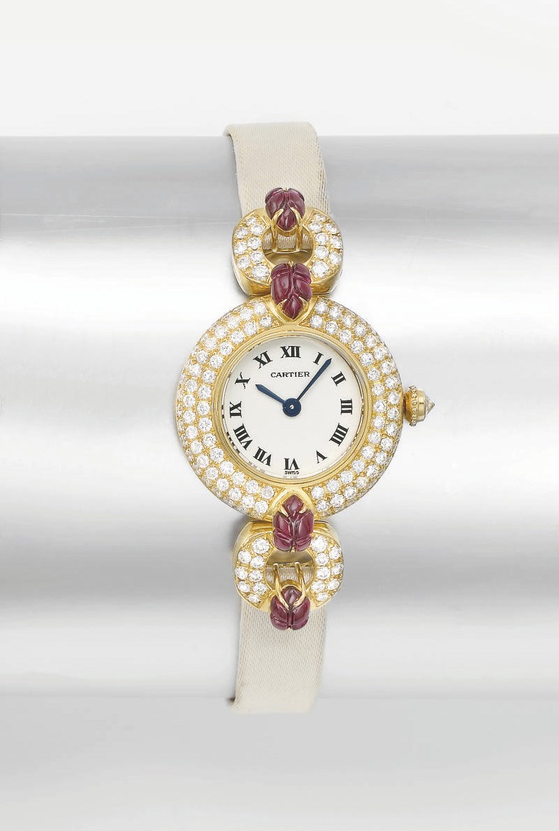 Cartier. A lady's fine 18K gold, diamond and ruby-set wristwatch