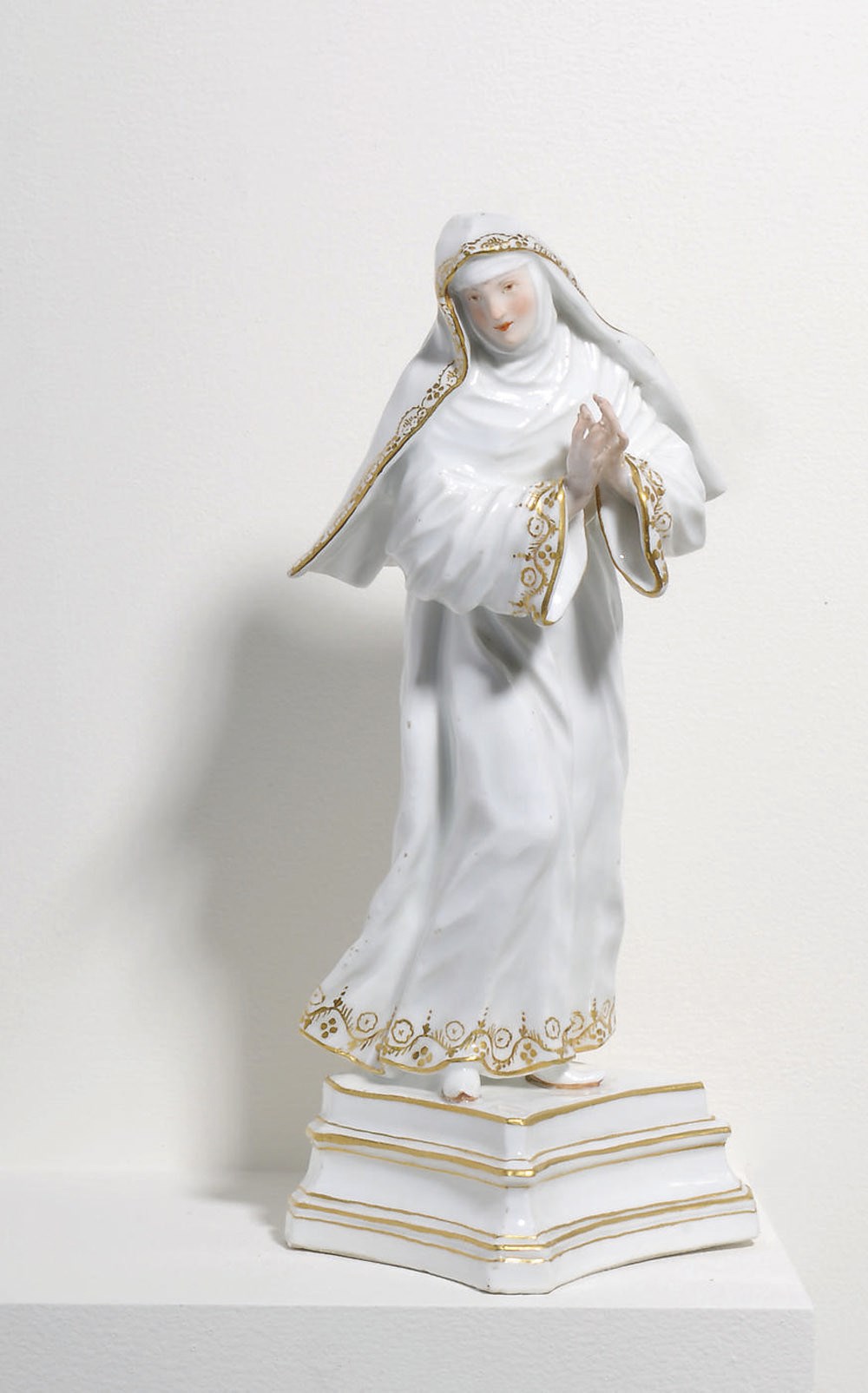 A MEISSEN PORCELAIN FIGURE OF A NUN