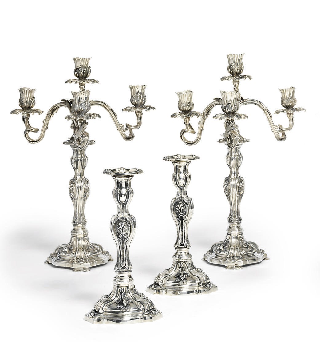 A PAIR OF PORTUGUESE SILVER FOUR-LIGHT CANDELABRA AND A PAIR OF CANDLESTICKS