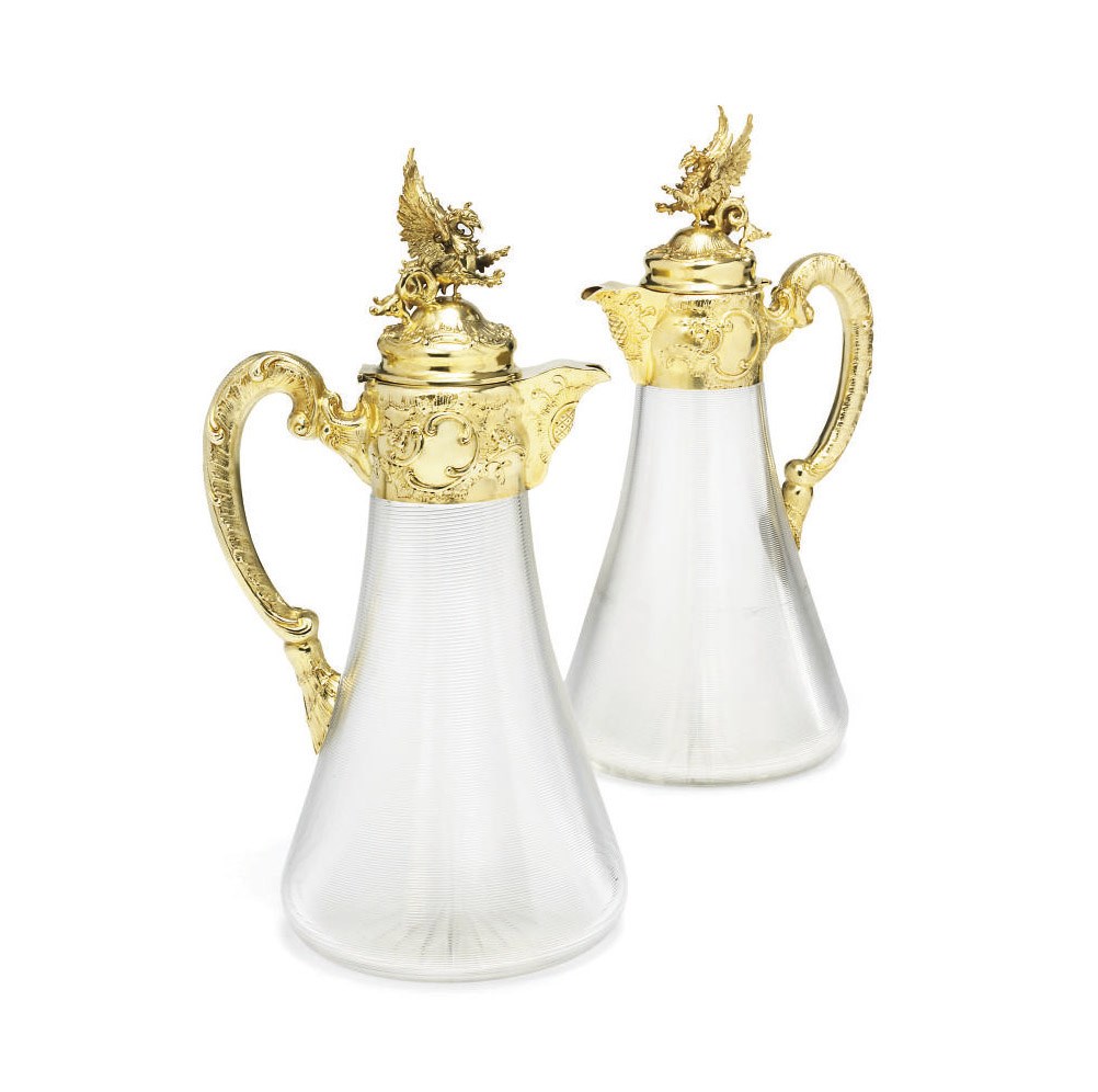 A PAIR OF AUSTRO-HUNGARIAN SILVER-GILT MOUNTED CUT-GLASS CLARET-JUGS
