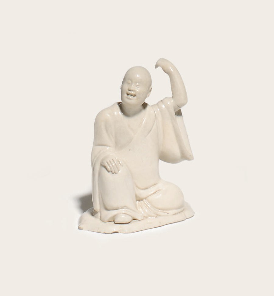 A STAFFORDSHIRE WHITE SALTGLAZE STONEWARE FIGURE OF A LOHAN