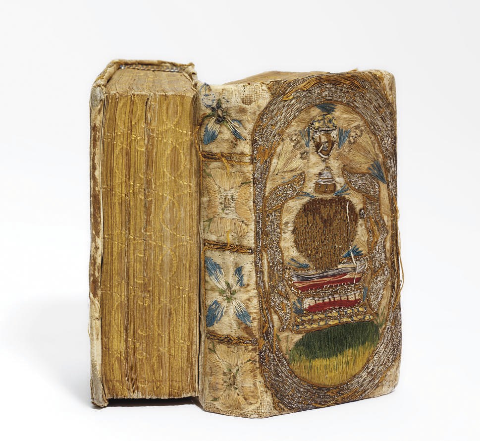 BINDING, Dos-a-dos -- The Book of Common Prayer. London: Bonham Norton and John Bill, 1625. [Bound with:] The New Testament. London: Bonham Norton and John Bill, 1626. 2 volumes in one, 24° (99 x 50mm). Book of Common Prayer imperfect. Contemporary embroidered dos-a-dos binding: white satin with chalice design on sides and quatrefoils on spines worked in coloured silk and silver wire (lightly worn), edges gilt and gauffered; modern blue morocco box with Thore Virgin cypher. Provenance: How family birth records of 1666-68 written on flyleaf -- Thore Virgin, 1926 (inscription, bookplate; Bib. Quarnforsiana, 1947, no. 276) -- [Rolf Wistrand]. STC 1927; D&M 405; STC 16364 (?). Sold as binding, not subject to return.