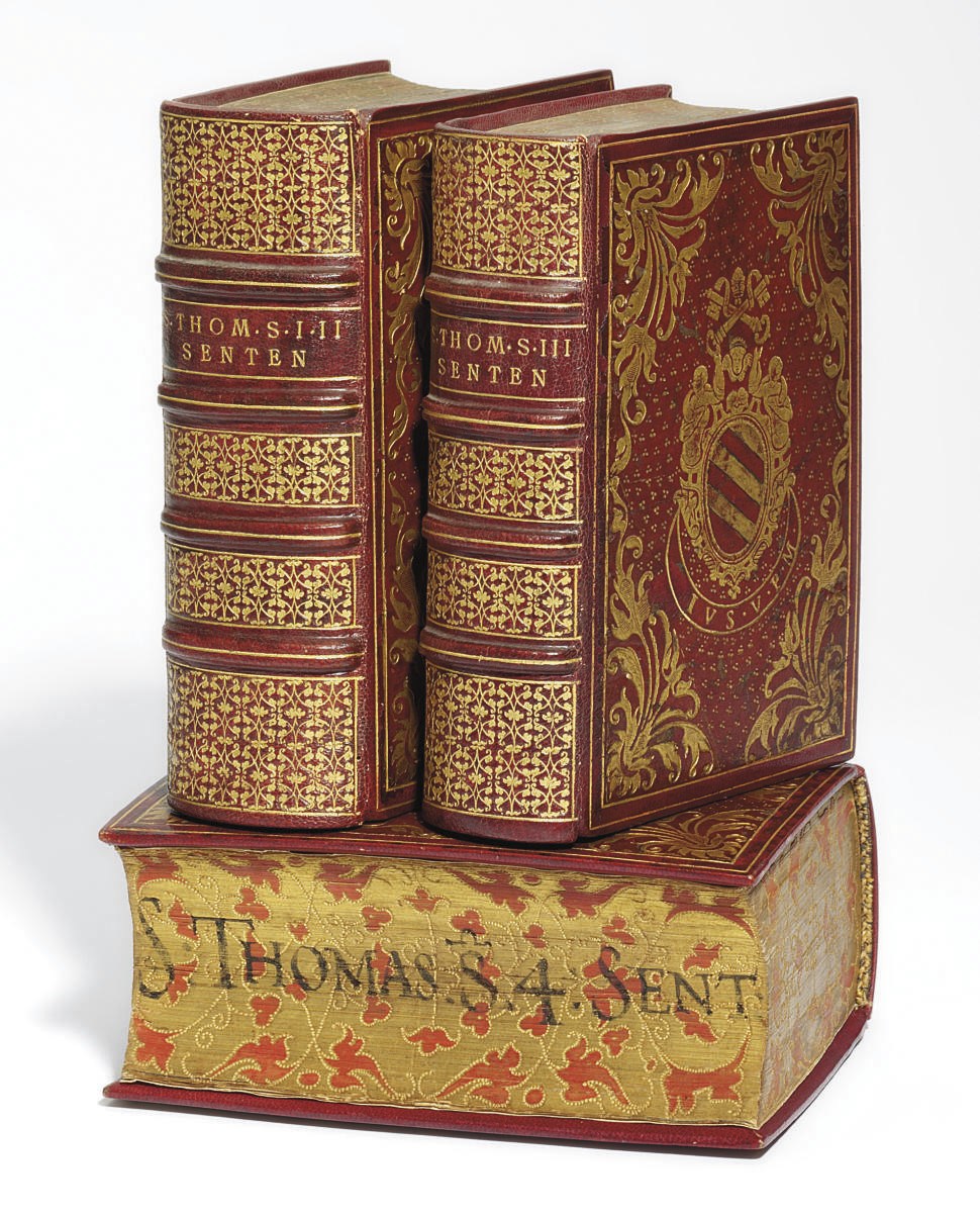 BINDING-- THOMAS AQUINAS (?1225-?1274). [Opera]. Lyons: J. F. Giunta & Soc. & J. Myt, 1520.  4 vols. in 3, 8° (162 x 104mm) Titles printed in red & black, woodcut title borders, initials (wormtrack in vol. I with a little loss.) 16th-century red morocco, elaborately gilt, with arms of Pope Pius V in centre of both covers, edges gilt, painted & gaufferd to a floral design, titles written along fore-edges, section of original backstrip inserted in one volume. Provenance: Michele Ghisleri, Pope Pius V (1566-1572) -- Charles and Mary Lacaita (bookplate) -- Thore Virgin, 1938 (inscription; Bib. Quarnforsiana, 1947, no. 1520, stamp) -- [Rolf Wistrand].