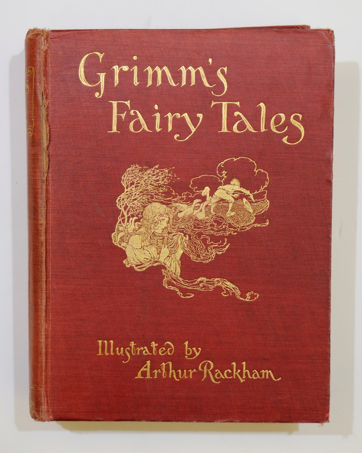 RACKHAM, Arthur (1867-1939, illustrator) -- Alfred E. BONSER (and others).  The Land of Enchantment. London: Cassell, 1907. 4° (275 x 215mm). Half title, frontispiece, title printed in red and black, tinted illustrations, some full-page, by Arthur Rackham (some light staining). Original green pictorial cloth gilt (some erosion to head and foot of spine, corners rubbed, a little bowed). Provenance: stamp on front free endpaper. FIRST EDITION. Latimore & Haskell p.29: "These stories and illustrations appeared first in Little Folks between 1896 and 1902."