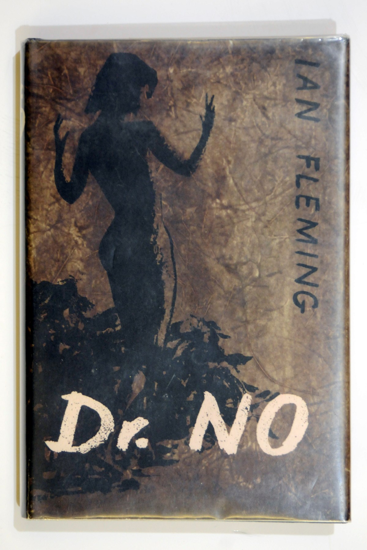 FLEMING, Ian (1908-1964). Dr. No. London: Jonathan Cape, 1958. 8°. Original black cloth, spine lettered in silver, front cover blocked in brown, original dust-jacket designed by Pat Marriott. FIRST EDITION.