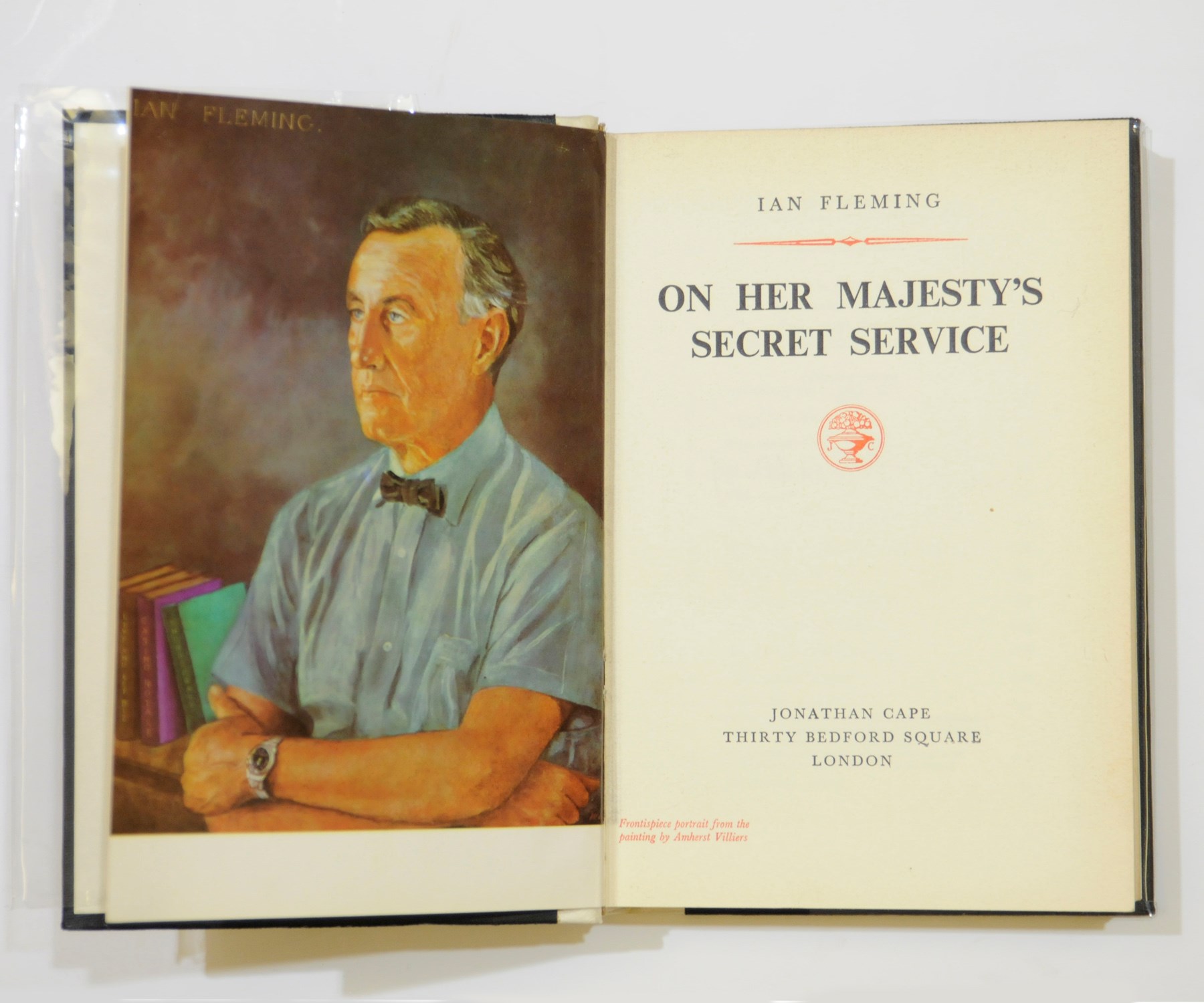 FLEMING, Ian (1908-64). On Her Majesty's Secret Service. London: Jonathan Cape, 1963. 8° (188 x 125mm). Half title, coloured frontispiece portrait of the author by Amherst Villiers, title printed in red and black. Original vellum-backed black cloth with white 'ski tracks' on the upper cover, spine lettered in gilt, top edges gilt, original glassine dust-jacket (jacket with small chips on the front panel, and short tears on the back panel).