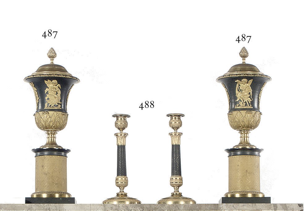 A PAIR OF RESTAURATION ORMOLU AND PATINATED BRONZE CANDLESTICKS