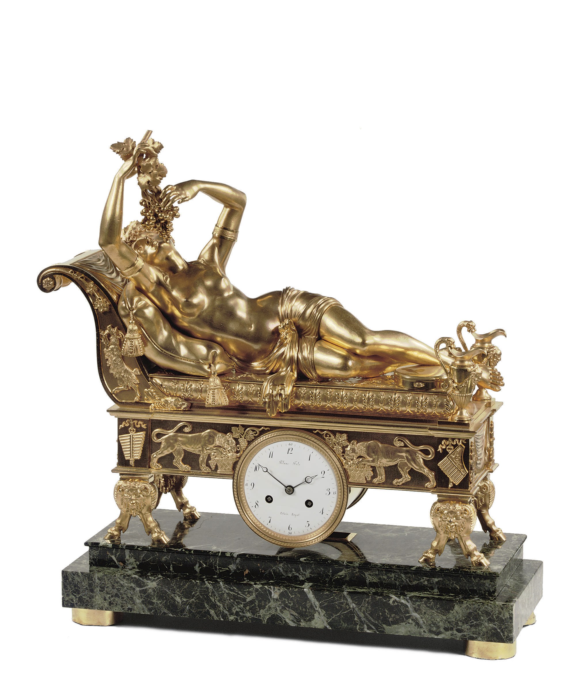 AN EMPIRE ORMOLU AND VERDE-ANTICO MARBLE FIGURAL STRIKING MANTEL CLOCK 'A LA BACCHANTE ALLONGEE'