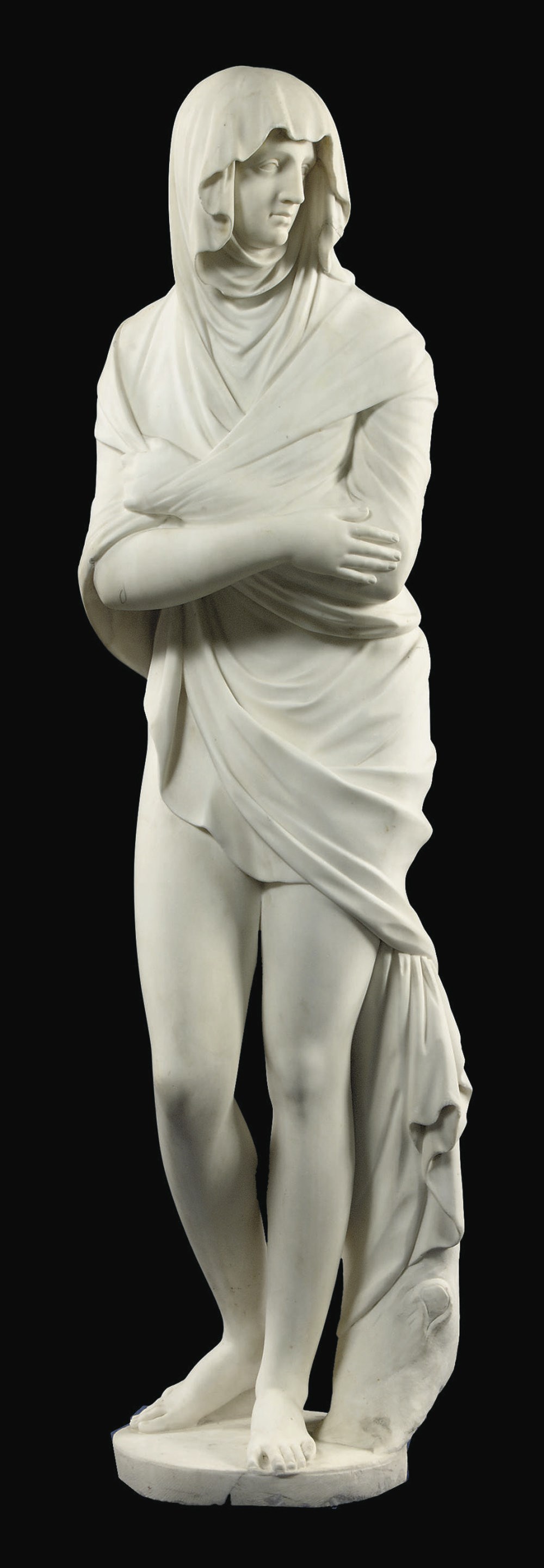 A CARVED MARBLE CLASSICAL FEMALE FIGURE REPRESENTING WINTER