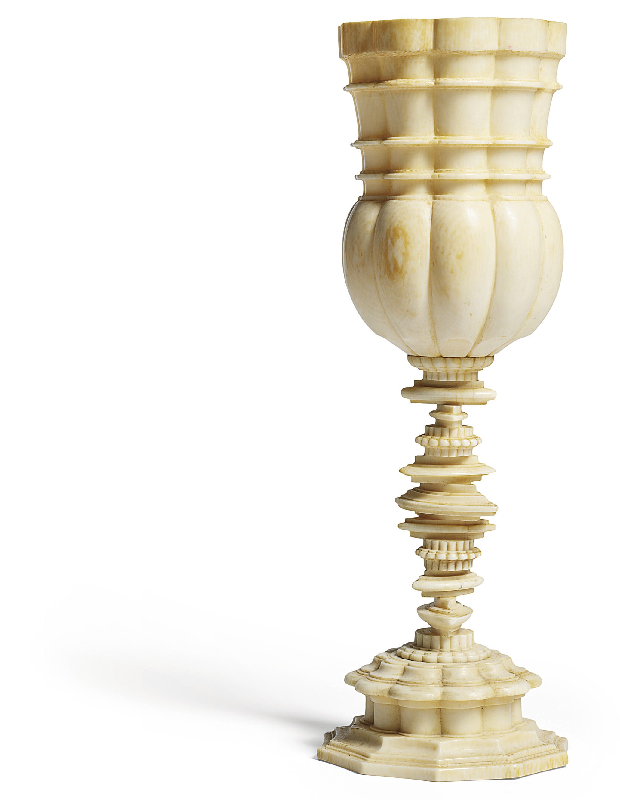 A GADROONED TURNED IVORY CUP