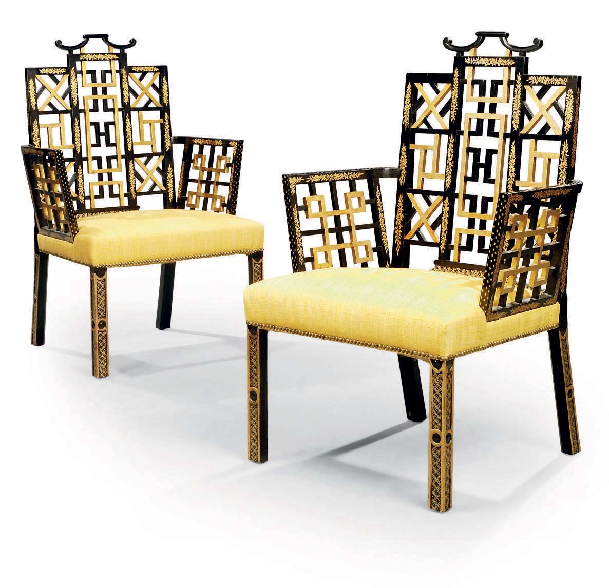 A PAIR OF BLACK PAINTED AND PARCEL GILT ARMCHAIRS