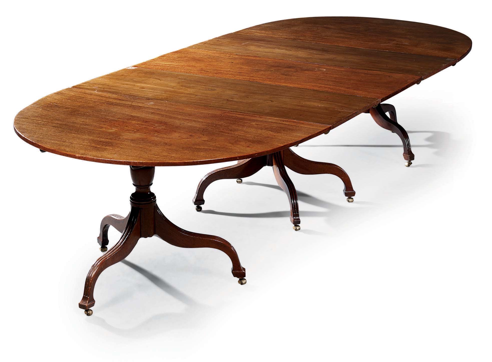 A GEORGE III MAHOGANY THREE-PEDESTAL DINING-TABLE