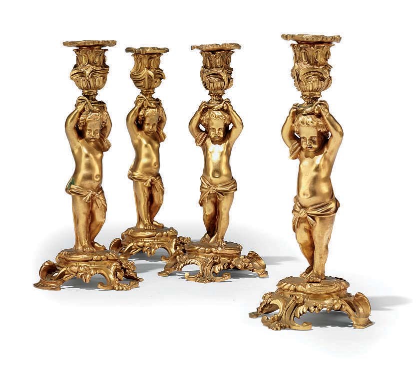 A SET OF FOUR FRENCH ORMOLU CANDLESTICKS
