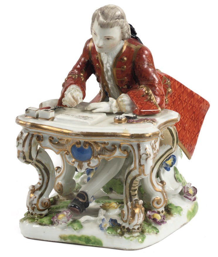 A MEISSEN PORCELAIN FIGURE OF A GENTLEMAN AT A DESK