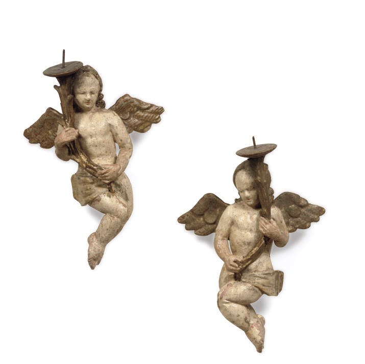 A pair of parcel-gilt and polychrome carved wood angels