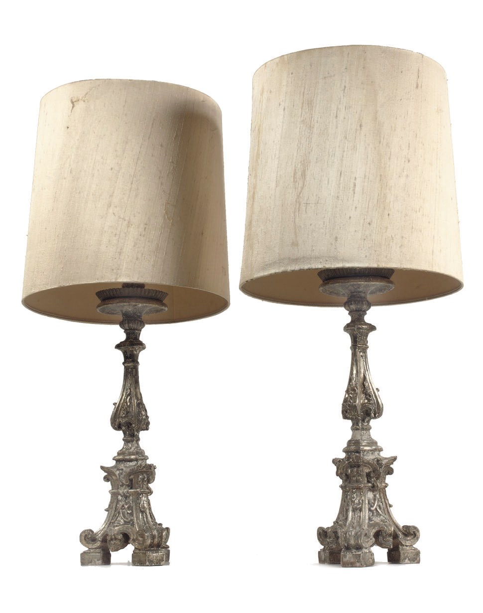 A pair of Italian silvered gilt-varnished alter candle sticks