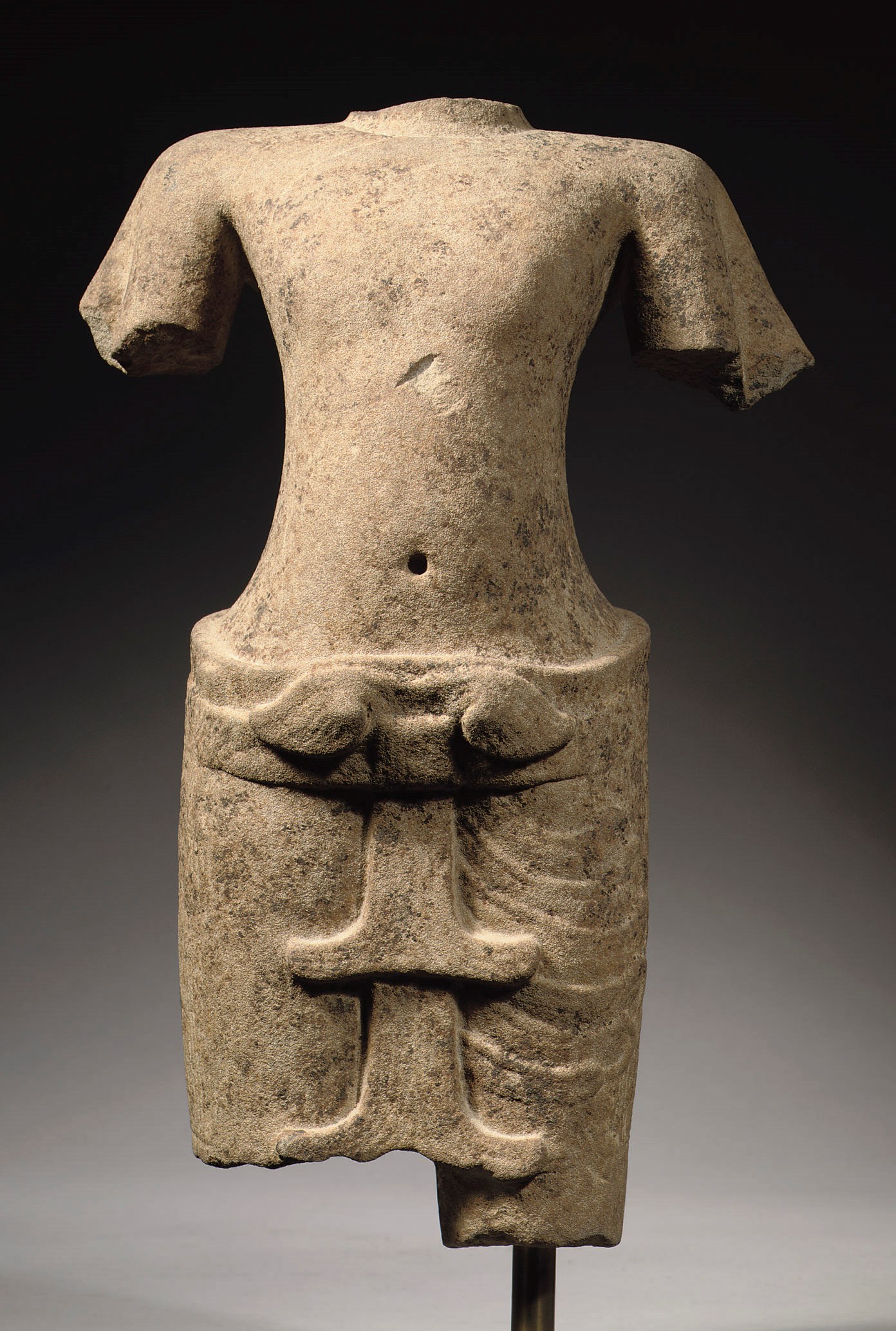 A Khmer Angkor Vat style sandstone torso of a Vishnu
