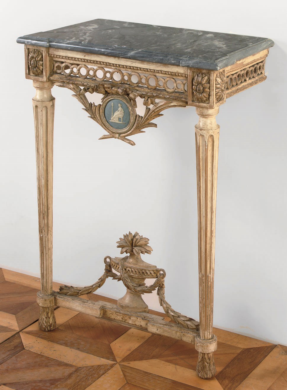 A NORTH EUROPEAN PARCEL-GILT AND WHITE PAINTED CONSOLE TABLE