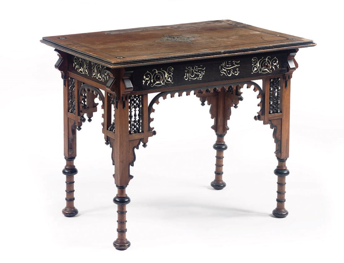 AN IVORY AND MOTHER-OF-PEARL INLAID WALNUT AND EBONIZED CENTRE TABLE