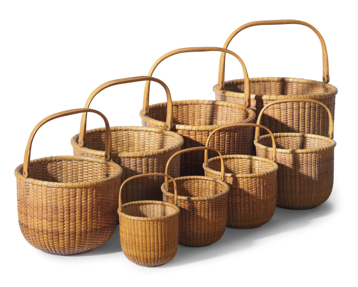 A Set of Eight Nesting Round Swing-Handle Lightship Baskets