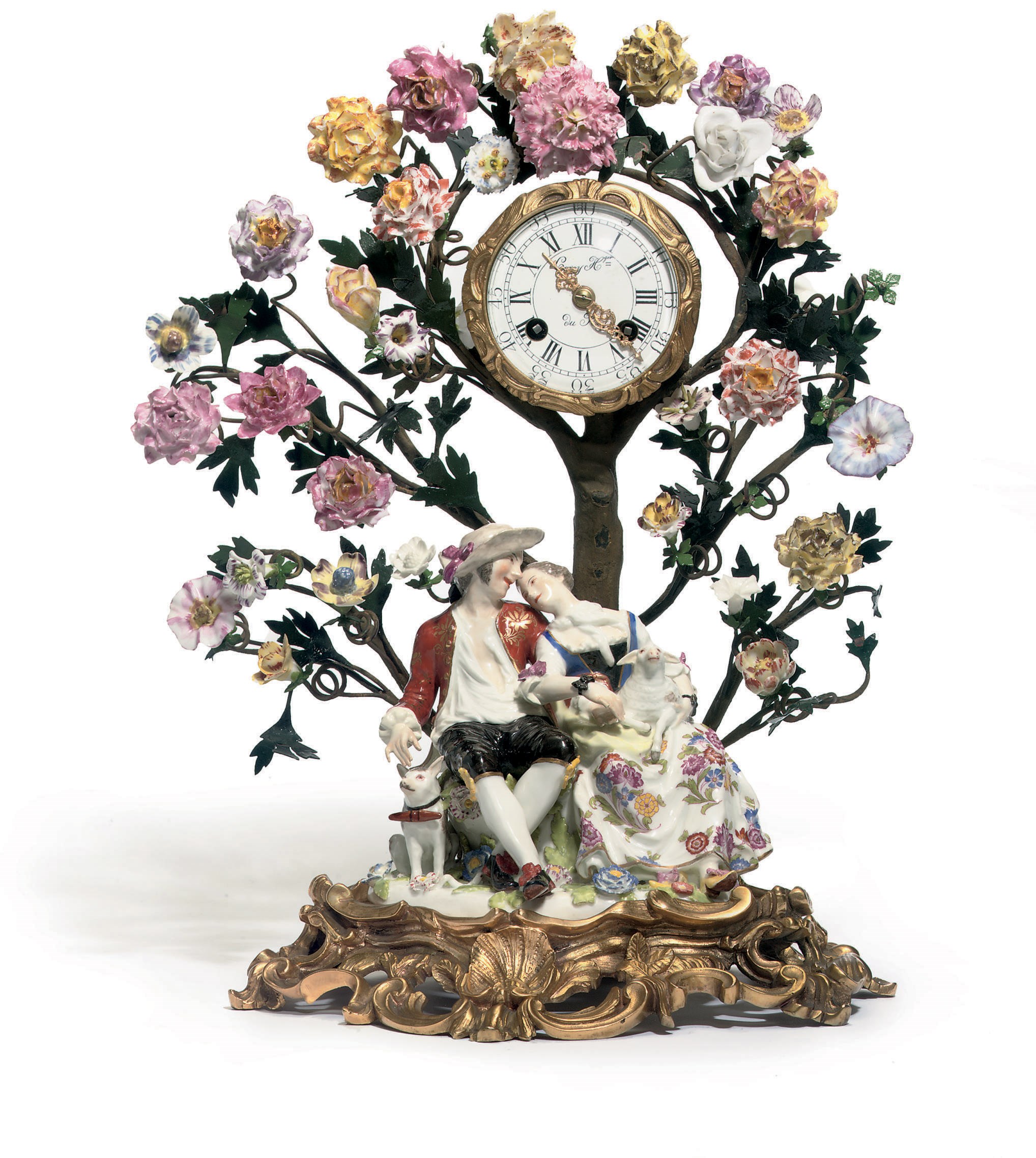 A MEISSEN GROUP OF SHEPHERD AND SHEPHERDESS EMBRACING AND AN ORMOLU-MOUNTED CLOCK ON BRANCH SUPPORT AND SCROLL-MOULDED BASE