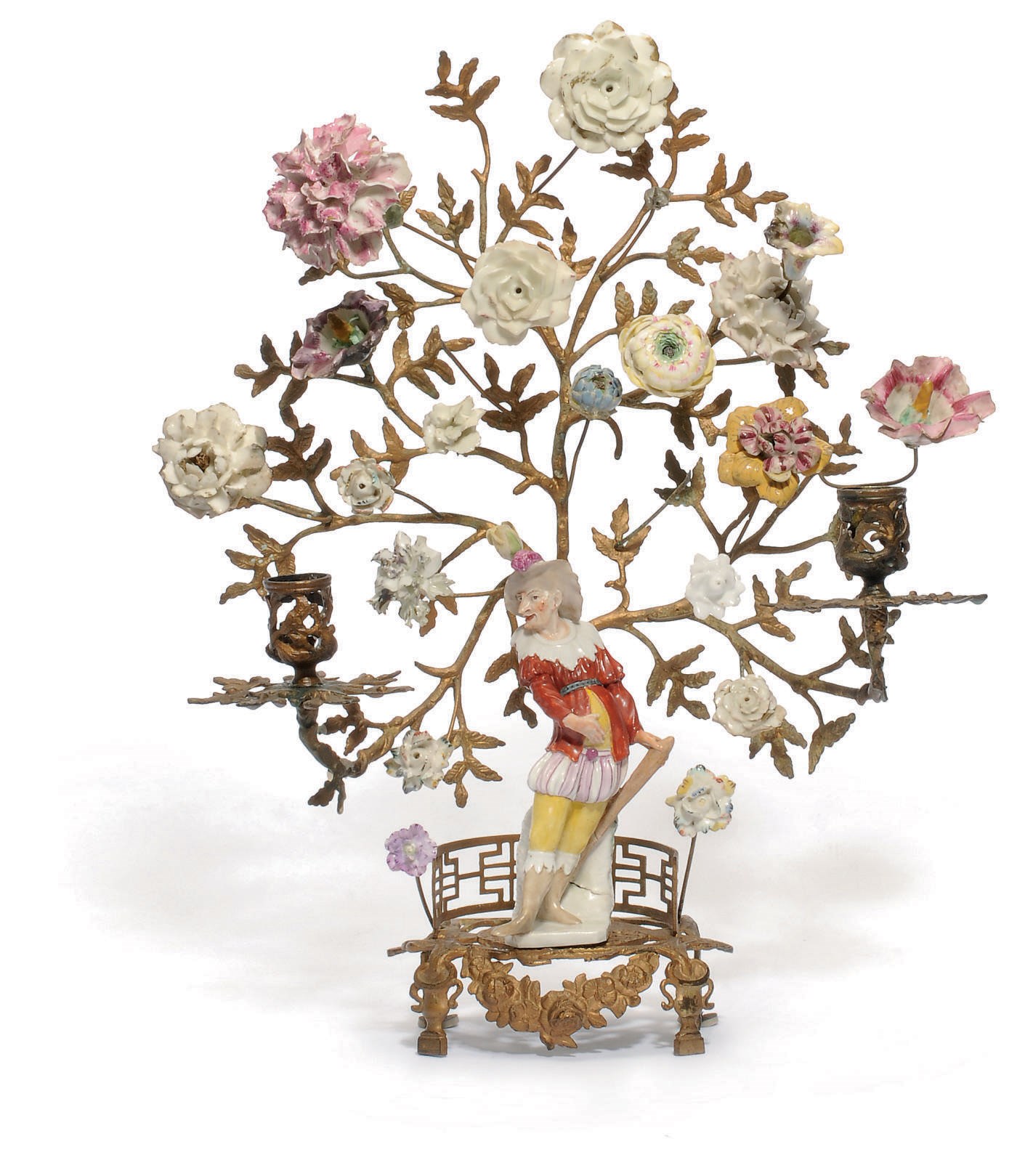 A MEISSEN FIGURE OF AN ACTOR FROM THE COMMEDIA DELL'ARTE ON A GILT-METAL BRANCHED CANDELABRA MOUNTED WITH PORCELAIN FLOWERS