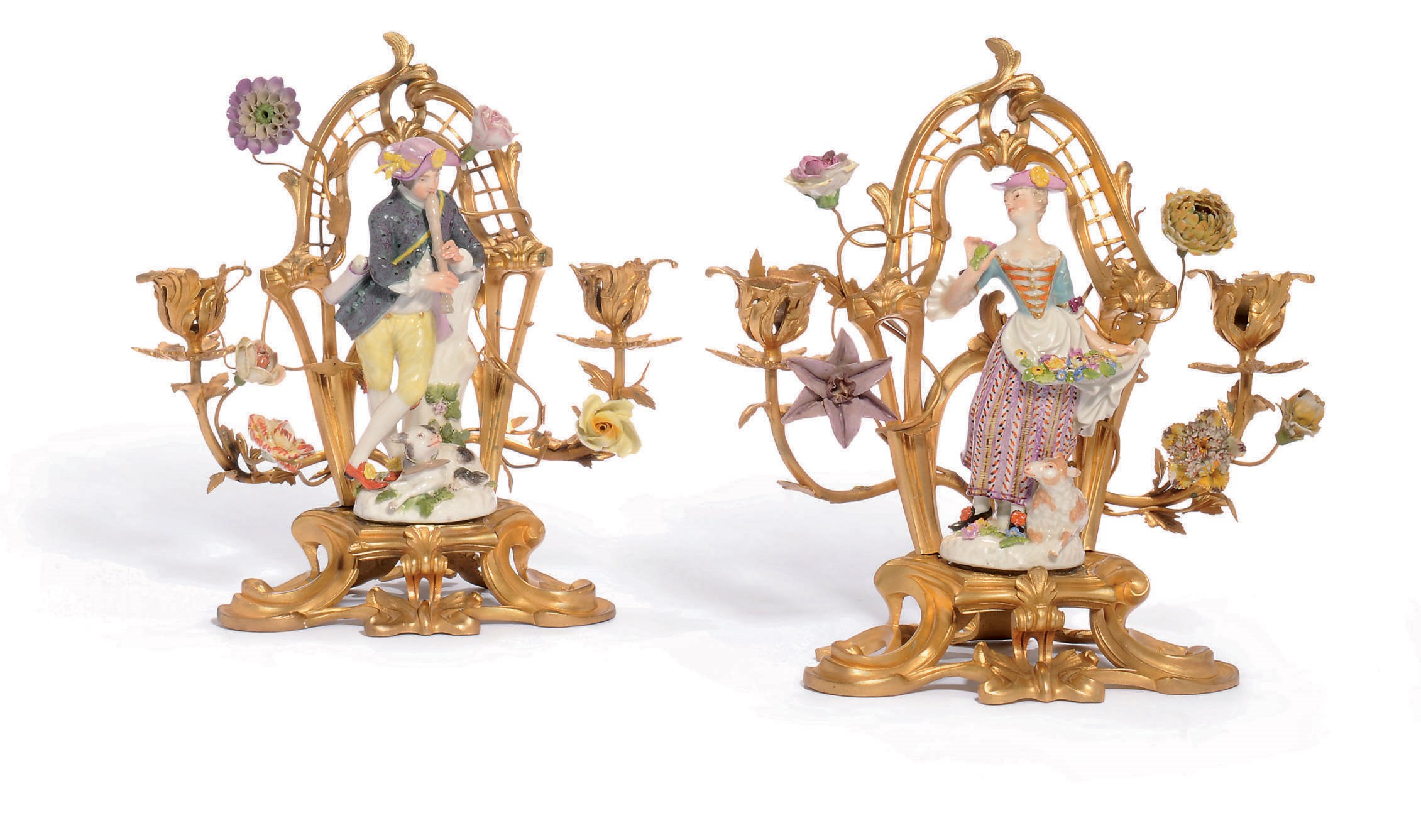 A PAIR OF MEISSEN FIGURES OF A SHEPHERD AND SHEPERDESS MOUNTED ON ORMOLU CANDELABRA BASES