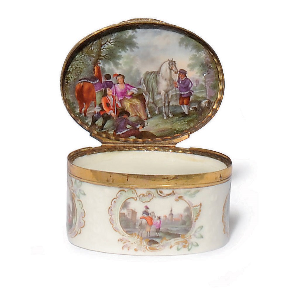 A GERMAN PORCELAIN GILT-METAL MOUNTED OVAL SNUFF-BOX AND COVER