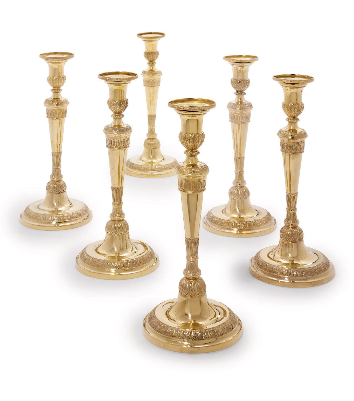 A SET OF SIX GILT-COPPER CANDLESTICKS