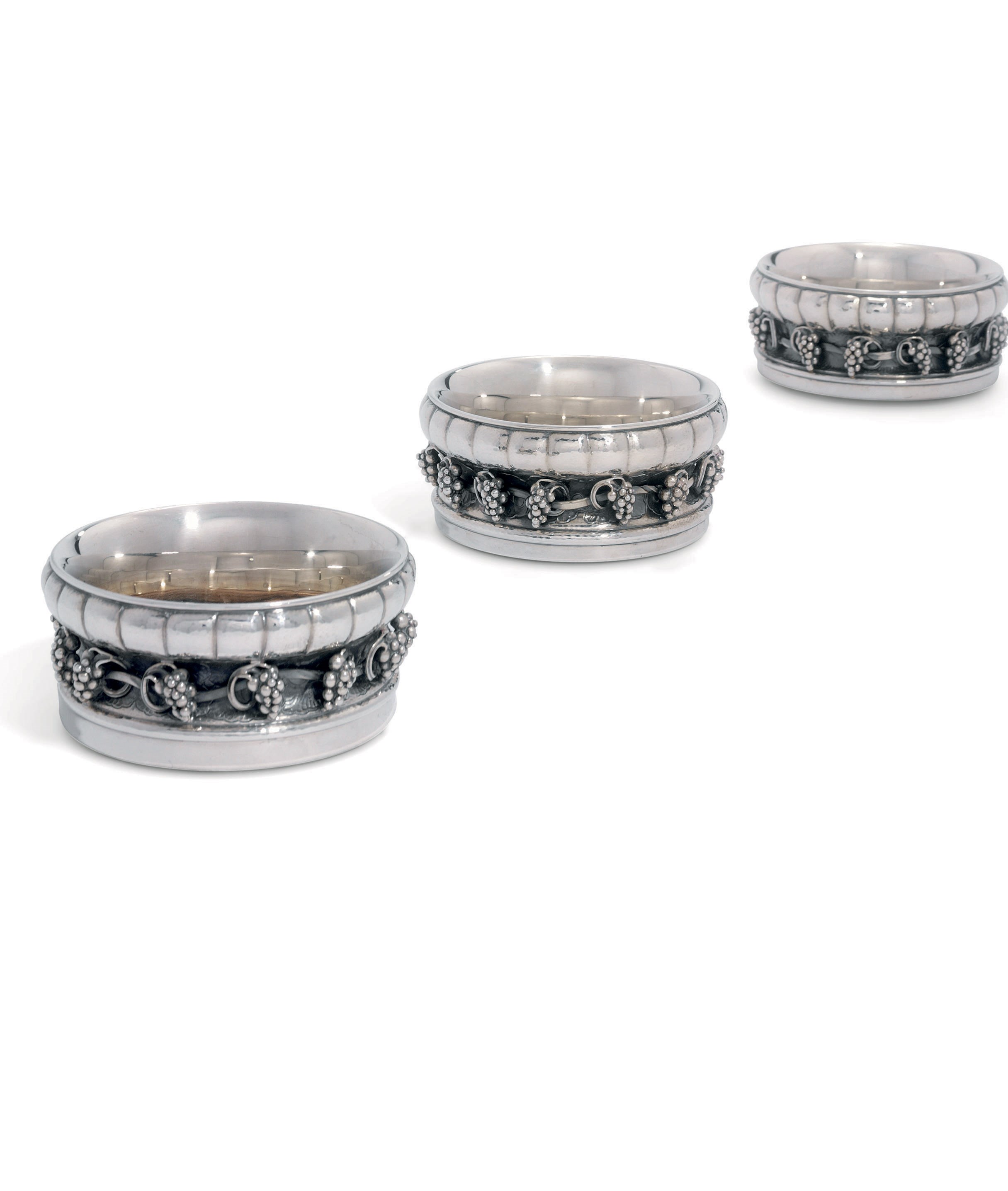 A SET OF THREE DANISH WINE-COASTERS DESIGNED BY GEORG JENSEN