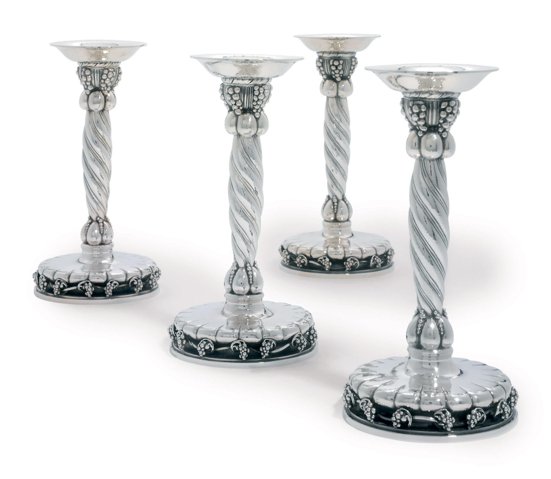 A SET OF FOUR DANISH CANDLESTICKS DESIGNED BY GEORG JENSEN