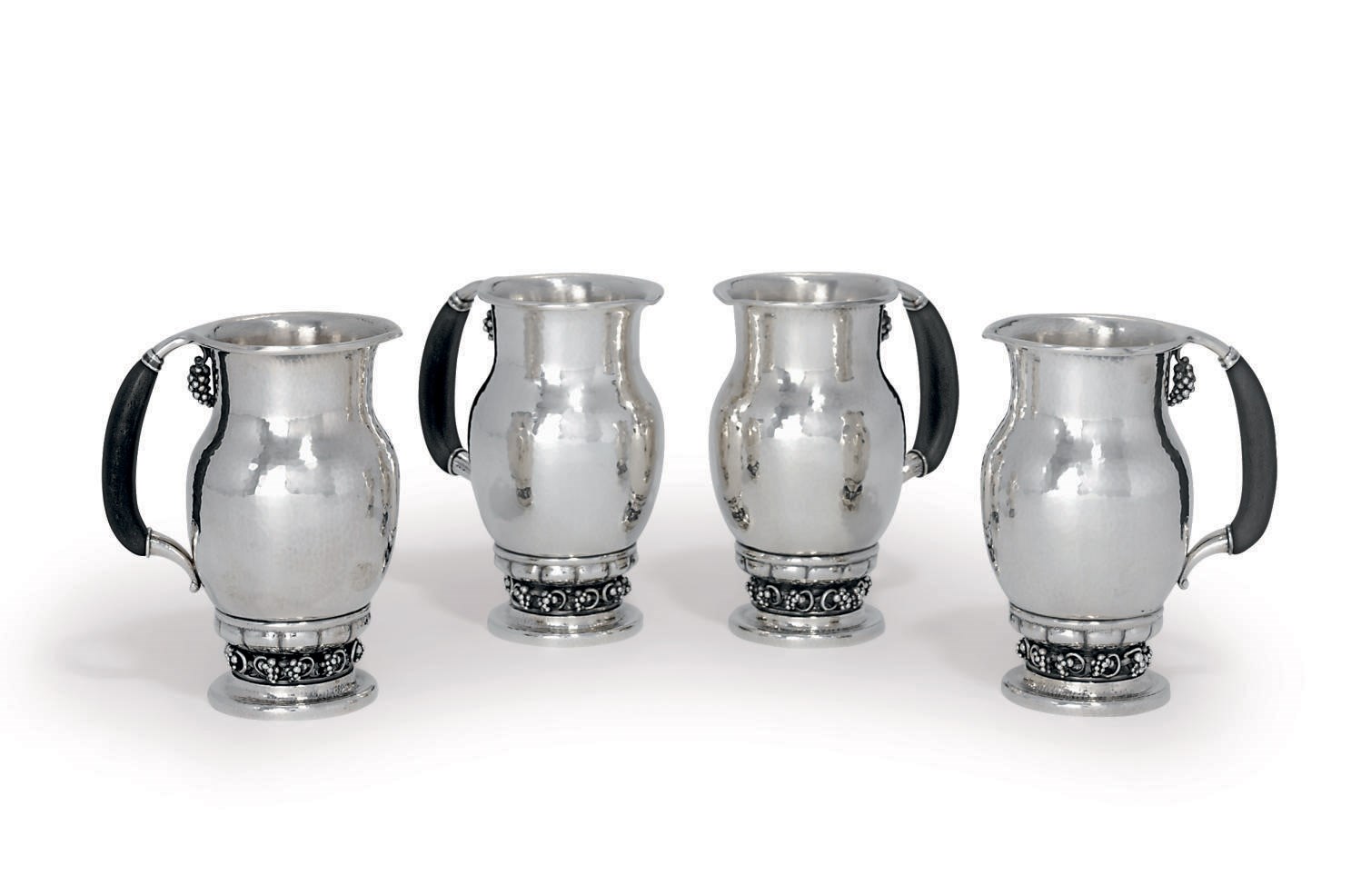 A SET OF FOUR DANISH PITCHERS DESIGNED BY GEORG JENSEN
