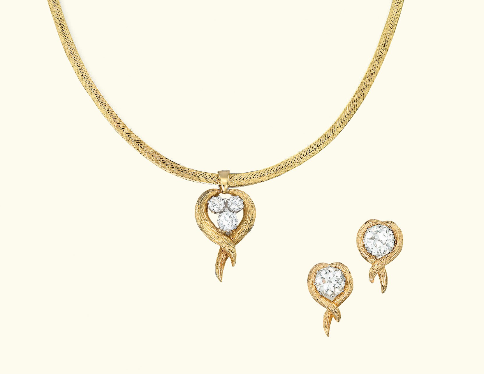 A DIAMOND-SET PENDANT AND A PAIR OF EAR STUDS