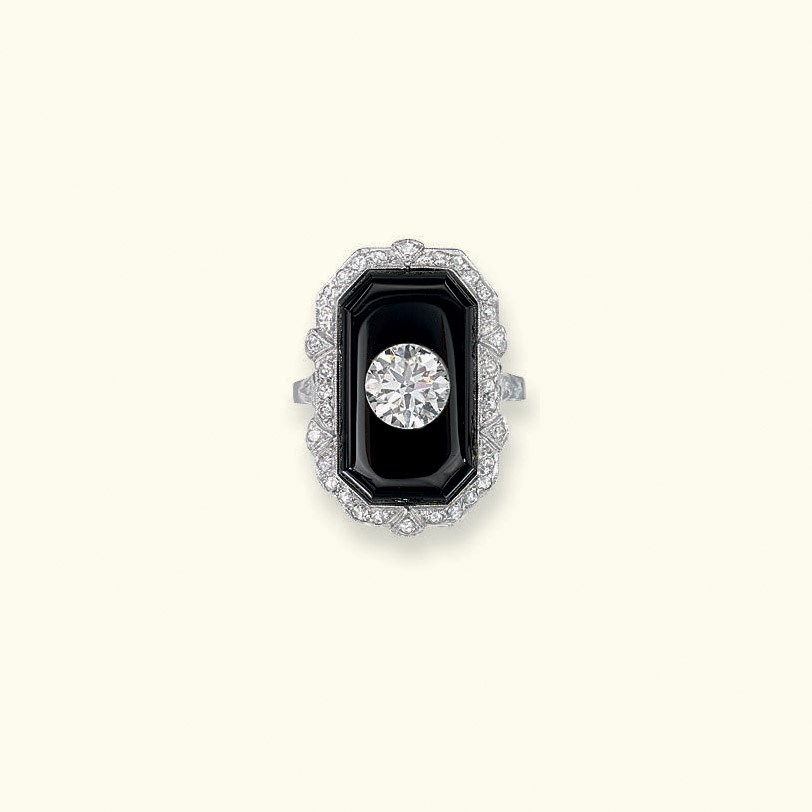 AN ART DECO ONYX AND DIAMOND RING