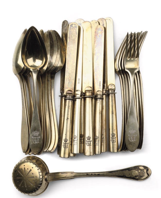 A Royal German set of ten silver-gilt dessert spoons, forks and knives and a caster sugar-spoon