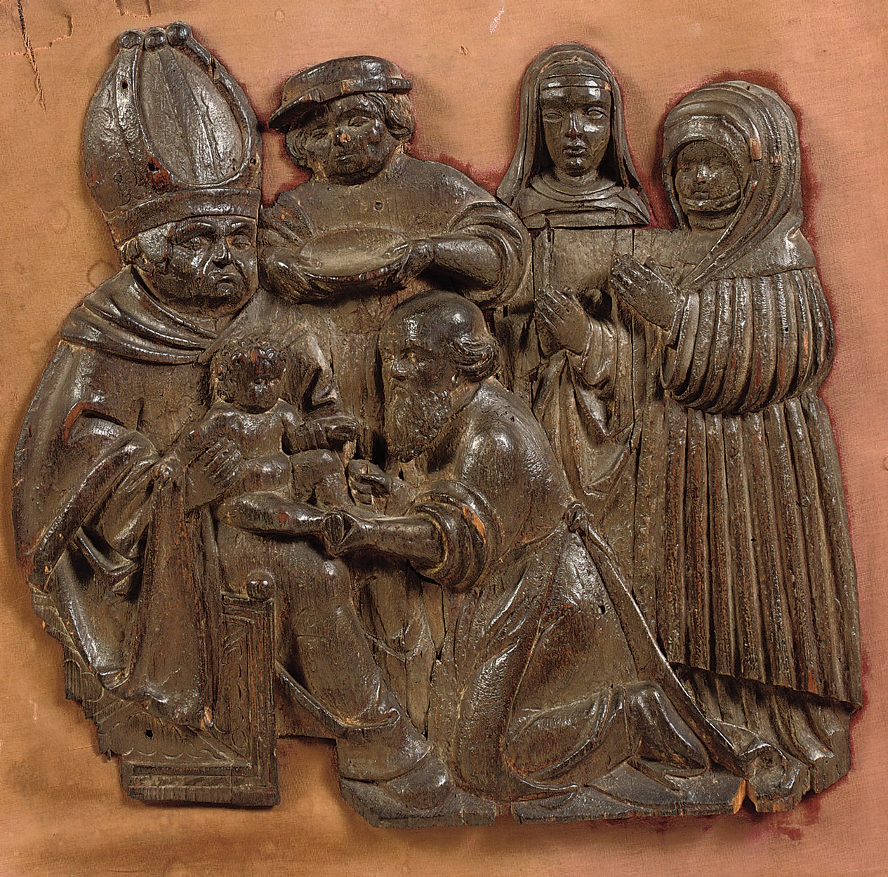 a carved wood relief of the circumcision