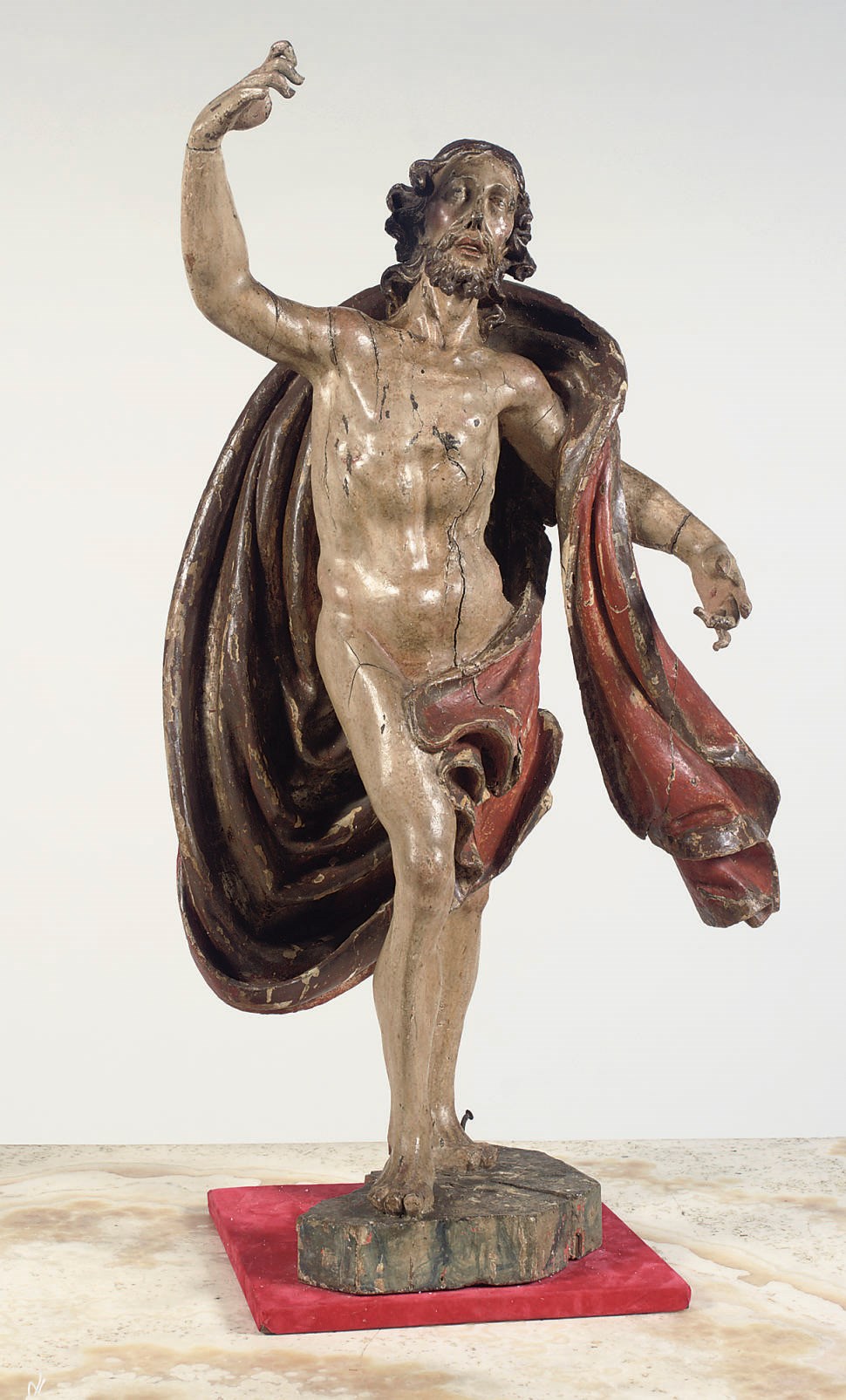 A POLYCHROME CARVED WALNUT FIGURE OF THE RISEN CHRIST