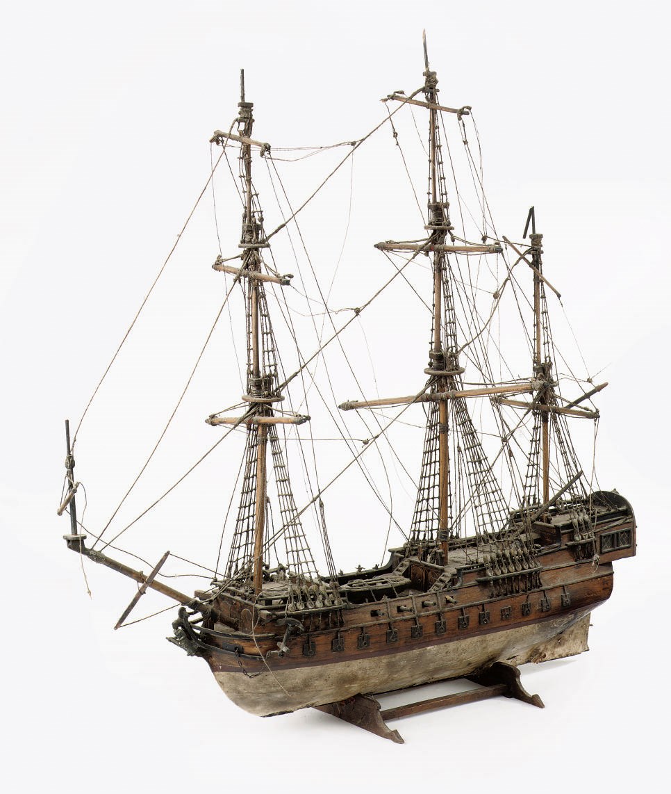 A RIGGED WOODEN MODEL OF A THREE-MASTED VESSEL