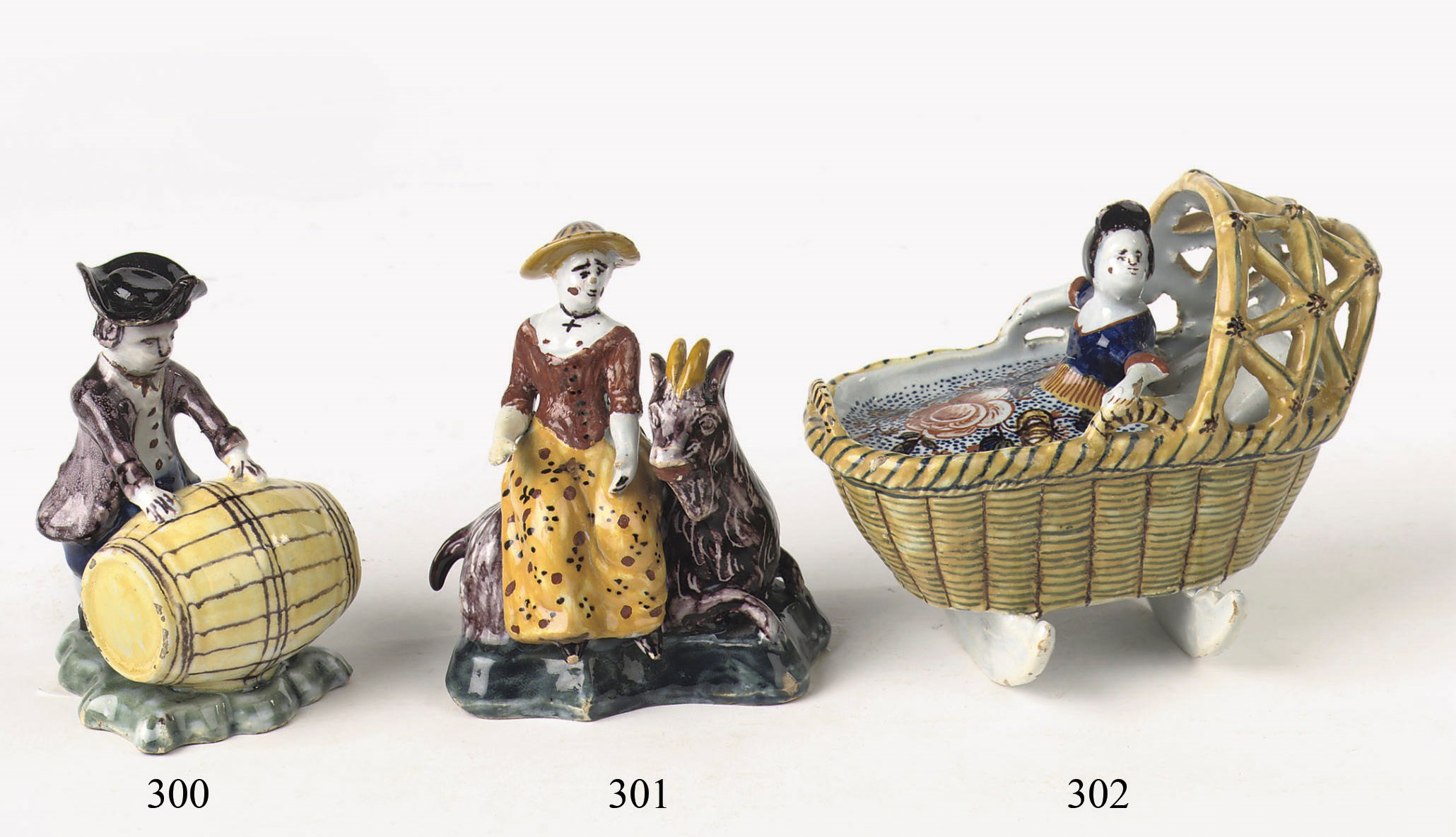 A Dutch Delft polychrome figure of a baby in a rocking cradle