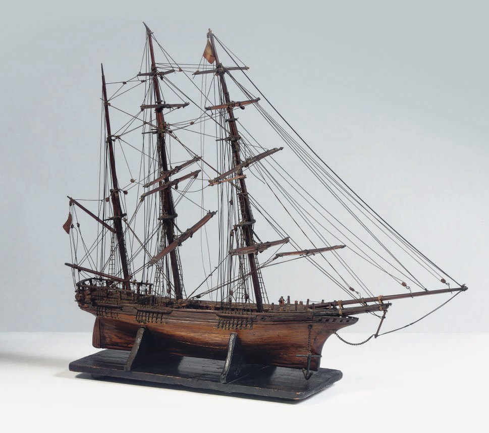 A FULLY RIGGED WOODEN MODEL OF A THREE MASTED VESSEL
