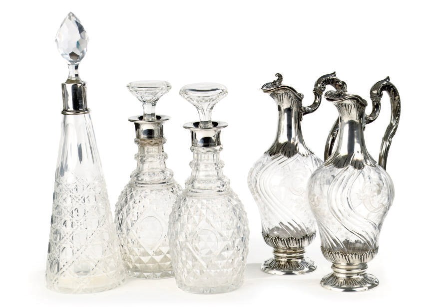 A pair of French silver-mounted glass claret jugs, a pair of silver-mounted flasks and a silver-mounted flask
