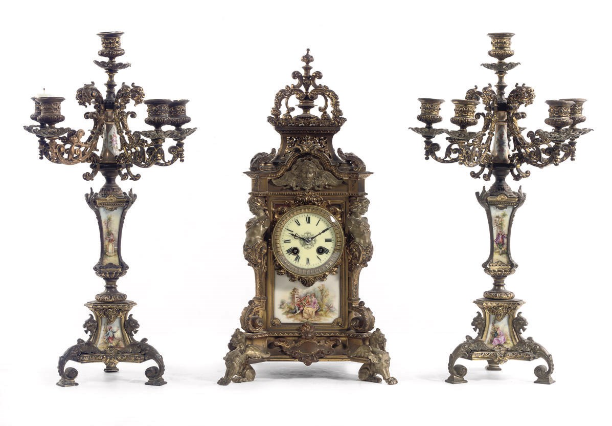 A GILT-BRONZE AND BERLIN 'SEGER' PORCELAIN THREE-PIECE CLOCK GARNITURE