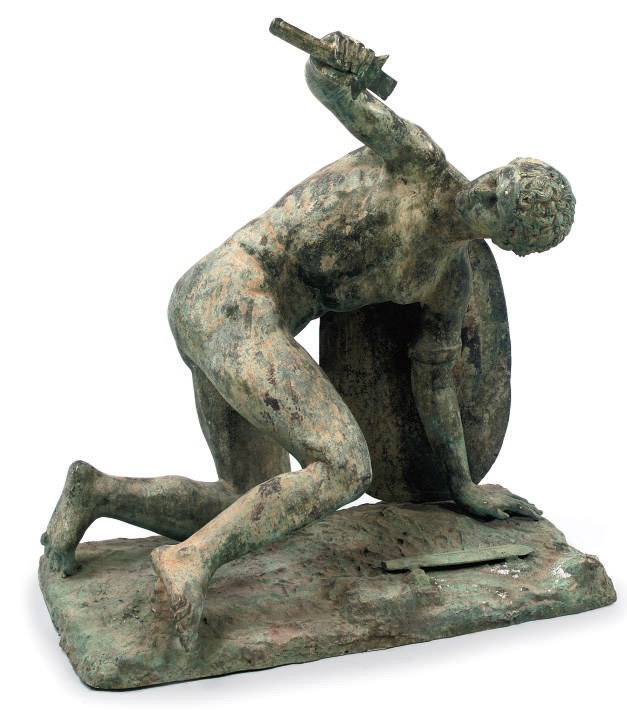 A BRONZE FIGURE OF A DEFEATED GLADIATOR