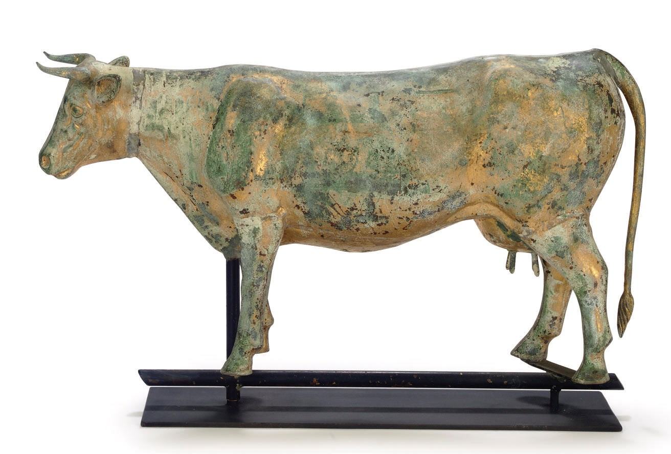 A MOLDED AND GILT COPPER AND ZINC COW WEATHERVANE