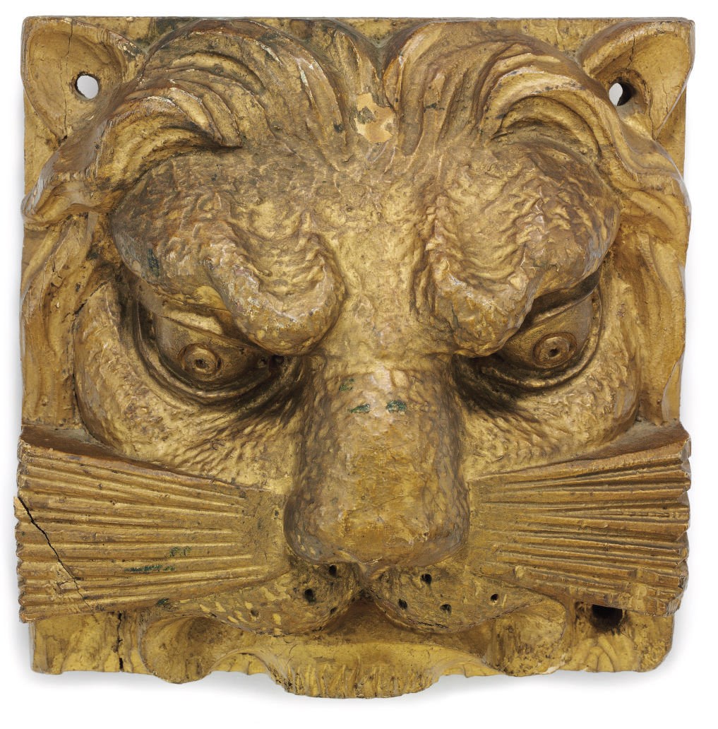 A CARVED AND PAINTED PINE LION FACE ARCHITECTURAL ELEMENT
