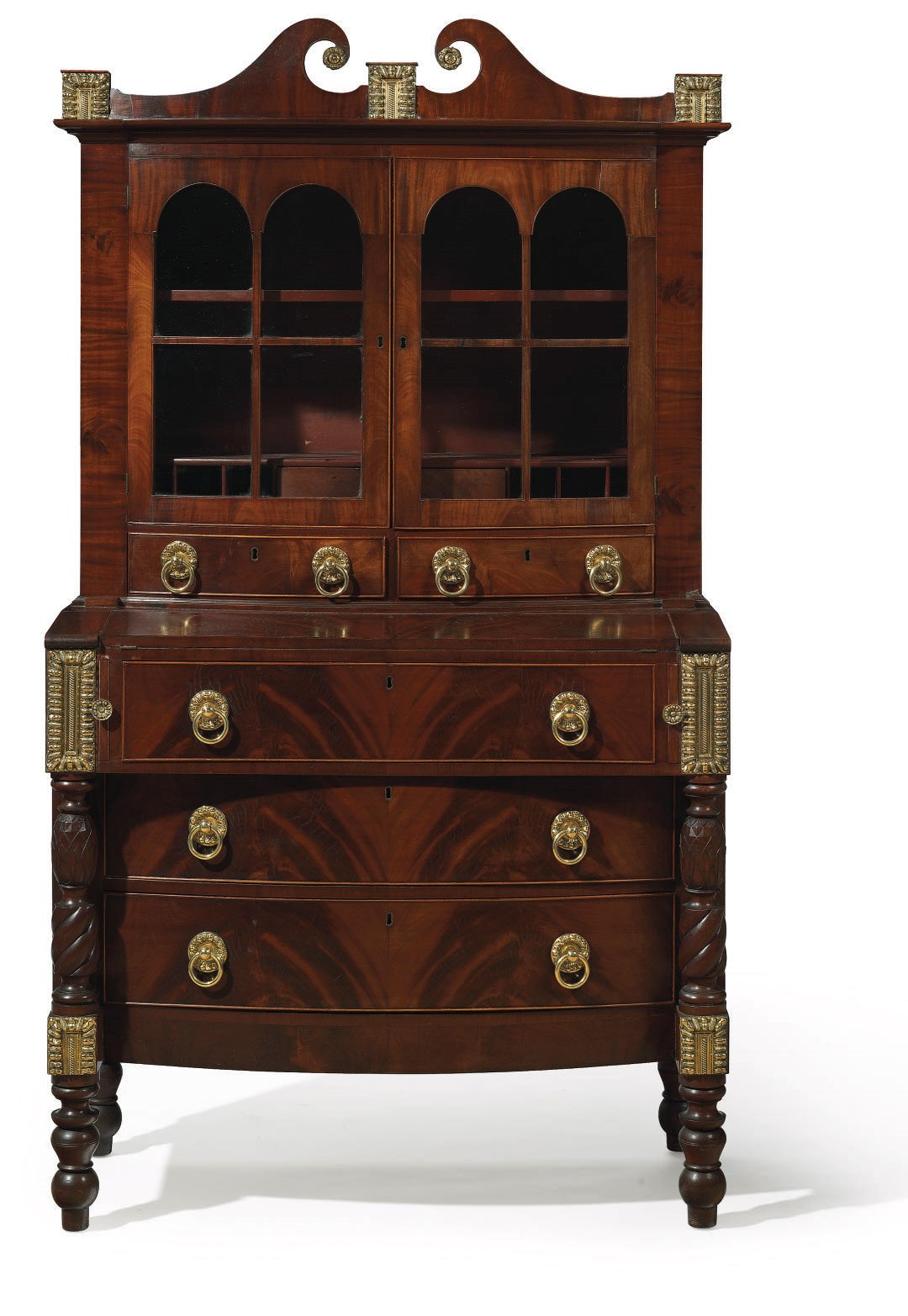 A LATE FEDERAL GILT METAL-MOUNTED MAHOGANY BOW-FRONT BUREAU-BOOKCASE