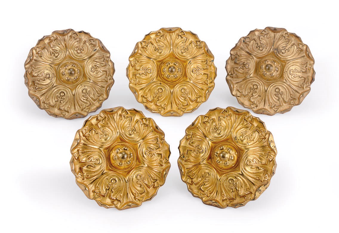 A SET OF EIGHTEEN GILT-BRASS CURTAIN TIEBACKS