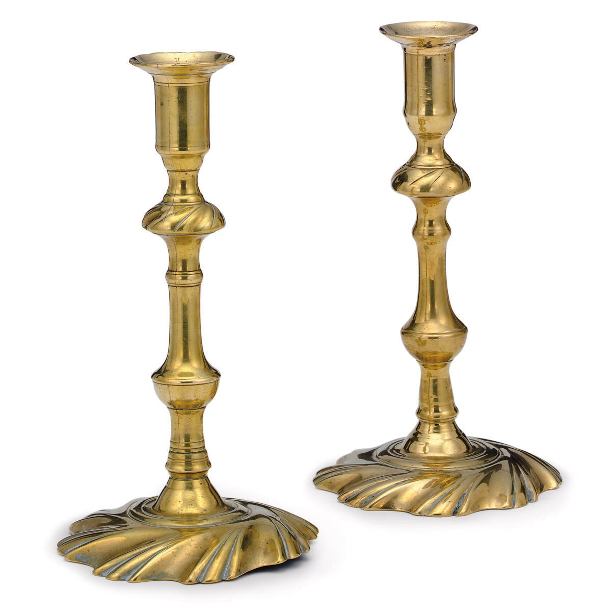 TWO SIMILAR GEORGE II SWIRL-BASE BRASS CANDLESTICKS