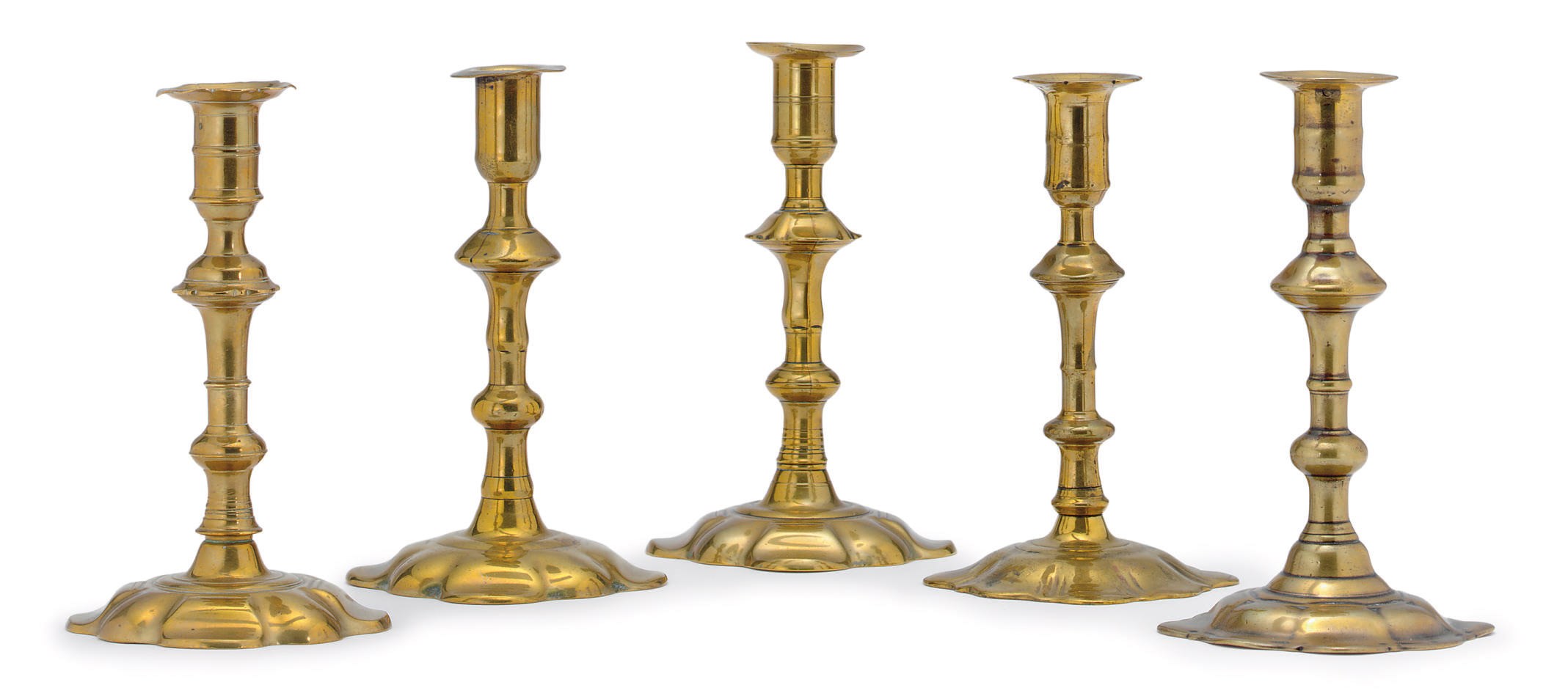 A MISCELLANEOUS GROUP OF FIVE MARKED GEORGE II BRASS CANDLESTICKS