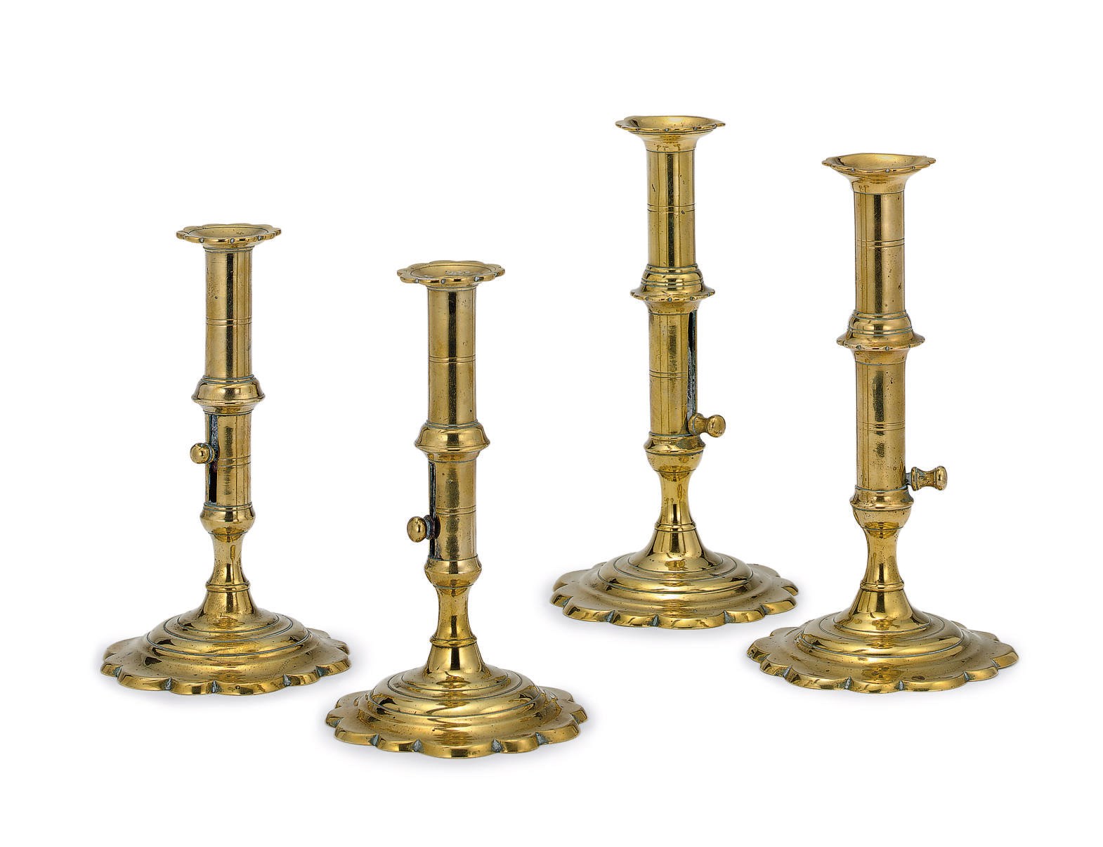 TWO PAIRS OF GEORGE II BRASS PETAL-BASE EJECTOR CANDLESTICKS